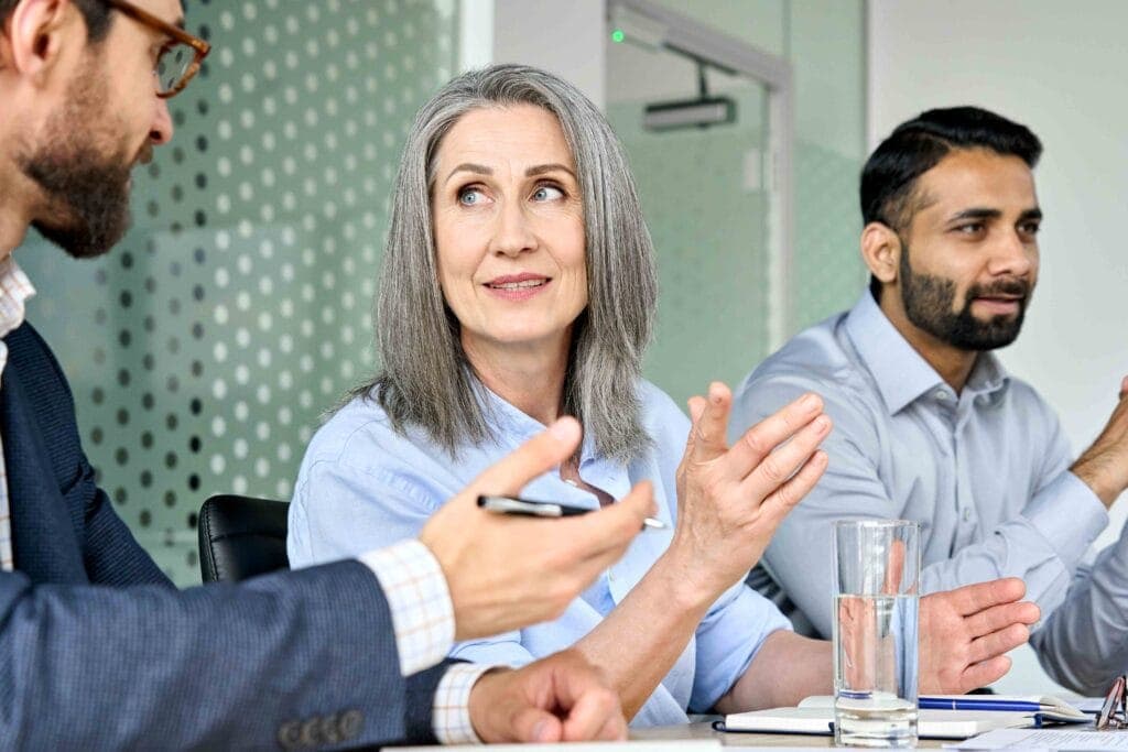 Senior managers in an urgent meeting discussing CQC enforcement action and interim management support
