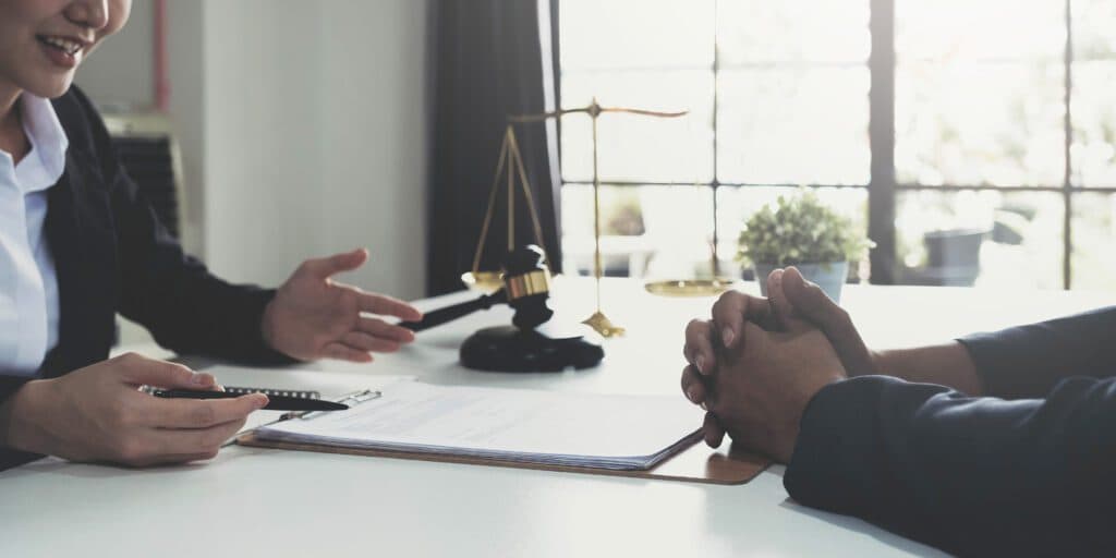 Business woman and lawyer reviewing contract papers