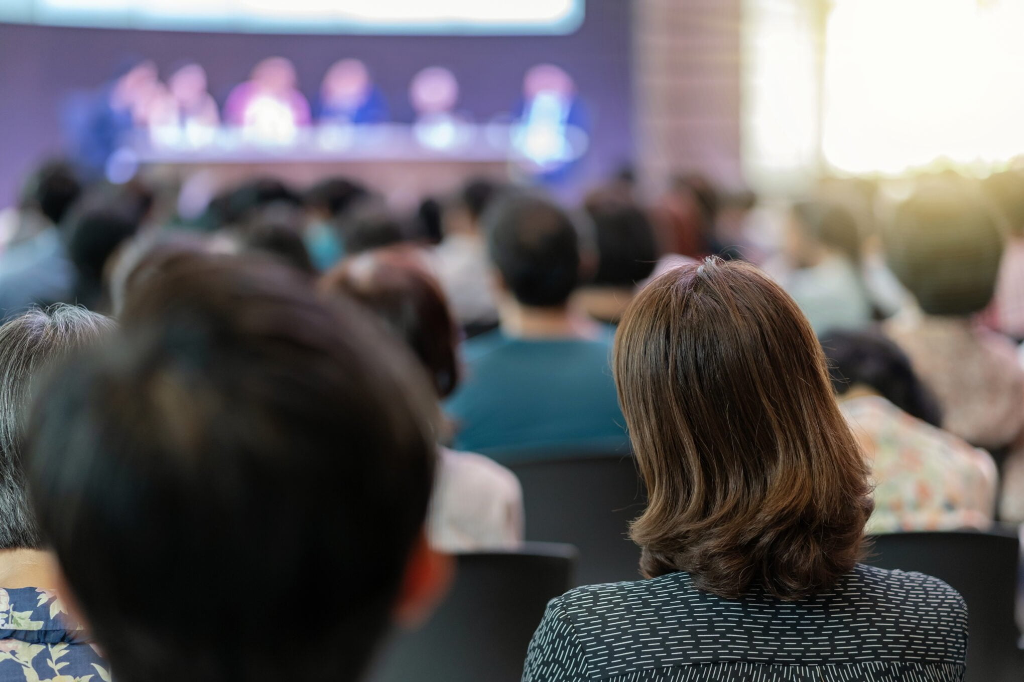Rear view of Audience in the conference hall or seminar meeting