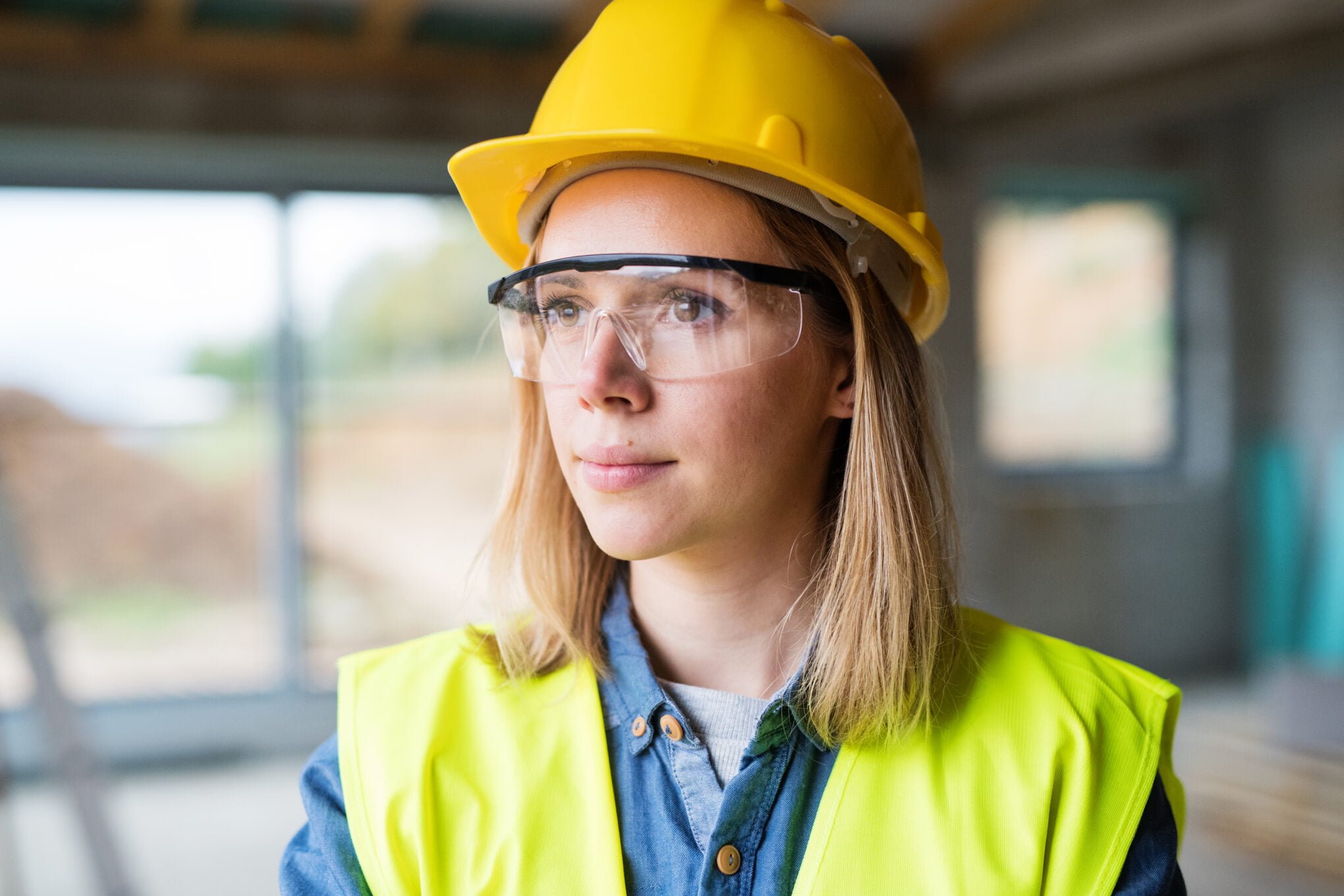 Young woman worker on the construction site.