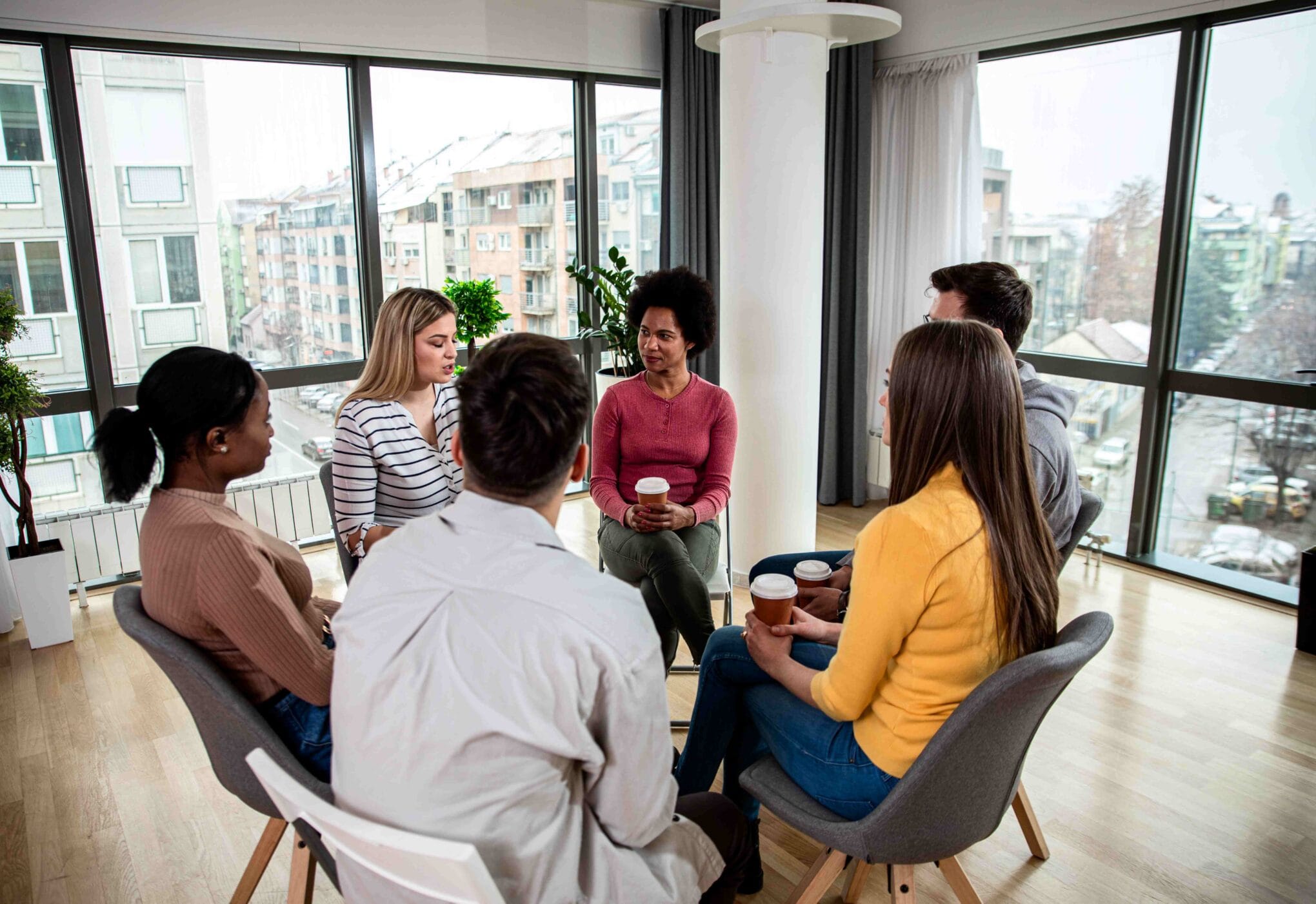 diverse-group-of-people-sitting-in-circle-in-group-2023-11-27-05-34-50-utc