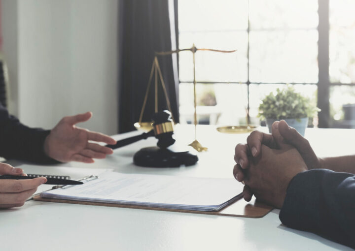 Business woman and lawyer reviewing contract papers